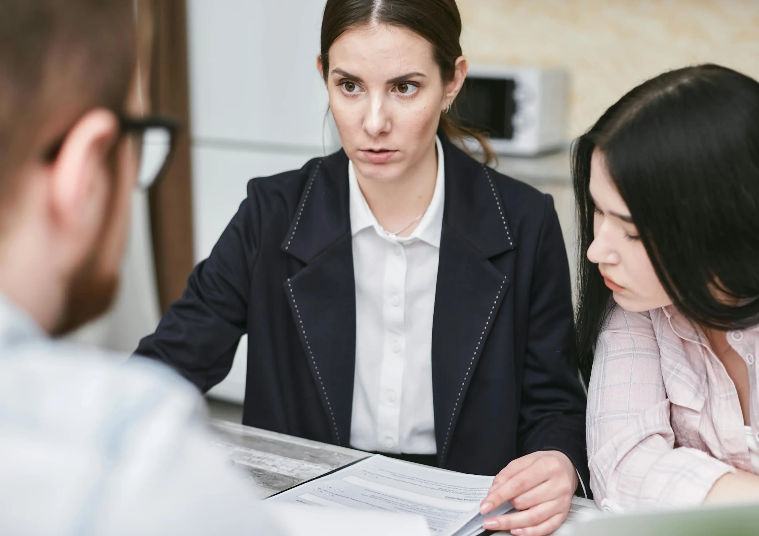 lady helping a couple do paper work